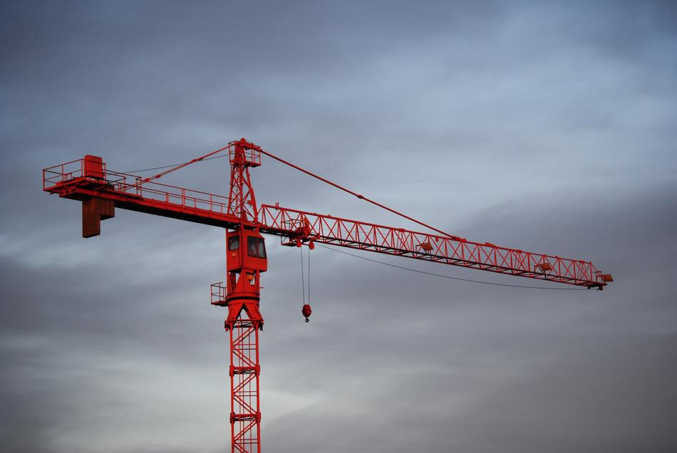 Red crane under the sky with dark clouds