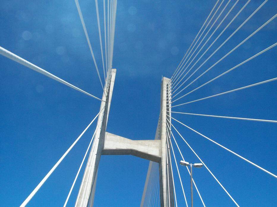 Shiny bridge in Victoria, Argentina, in sunlight, under the blue sky with bokeh lights