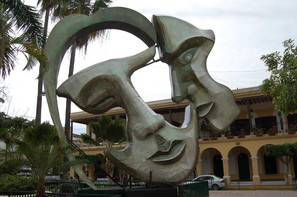 sculpture in the form of masks on the square in the park