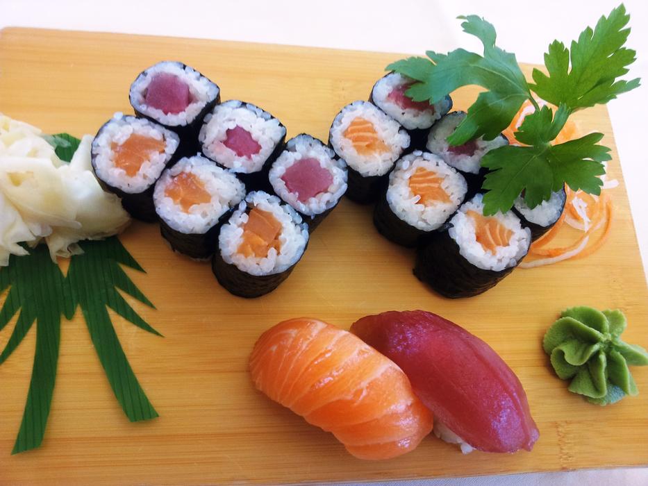 sushi with fish and green leaves