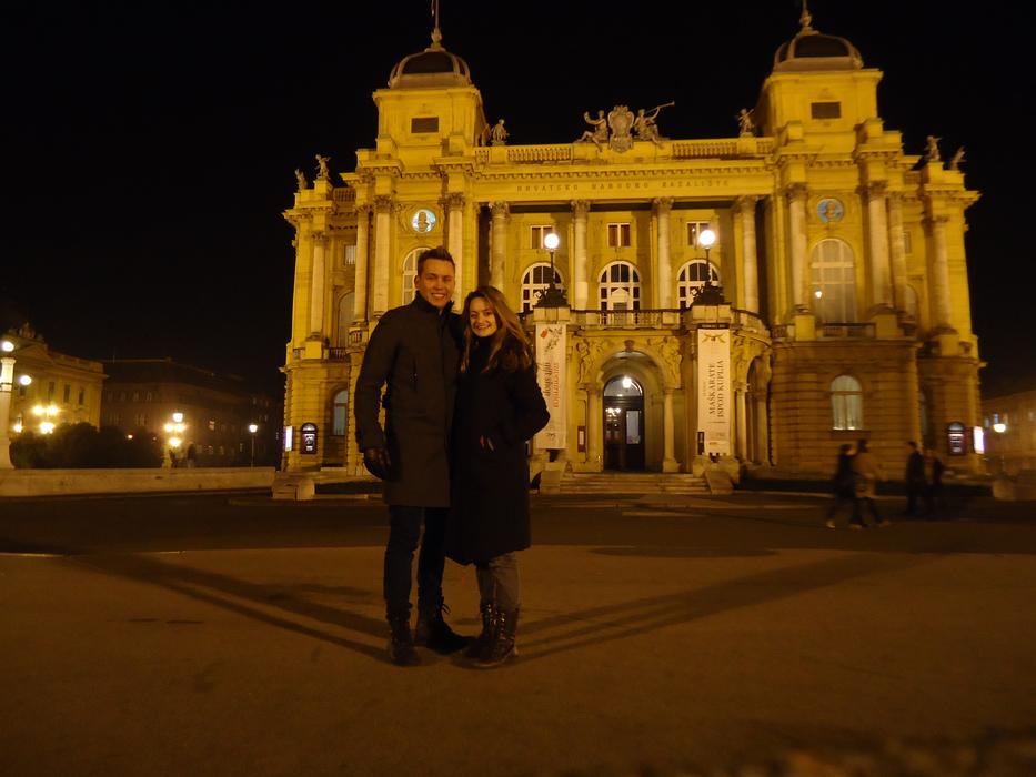 Couple near the beautiful theatre with lights, in Croatia, with lights