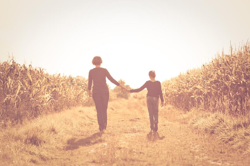 Mother Daughter walking on Field