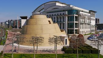 Ziggurat and colorful buildings, among the colorful plants, in Budapest, Hungary