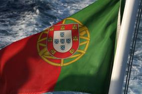 Flag Portuguese on a boat over the water close-up