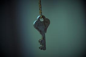 old key on a rope on a blurred background
