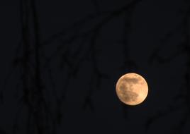 full moon in dark sky at night