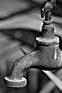 old rusty water tap close-up in monochrome