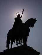statue of king matthias of hungary against the backdrop of the evening sky