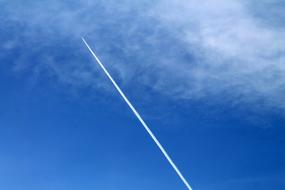 white airplane footprint on blue sky