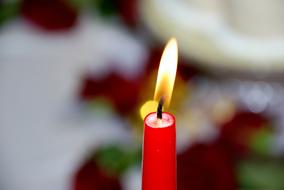 burning red Wax Candle at blur background