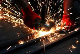 Person working with metal, with the tool, in the workshop