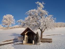 Winter hut on snowy hill