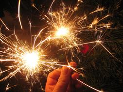 burning sparklers in man's hands