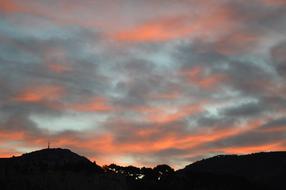Beautiful landscape with silhouettes of the mountains, at colorful and beautiful dawn with clouds