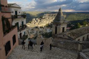 People in the beautiful and colorful Rogusa, Sicily, Italy, with hills