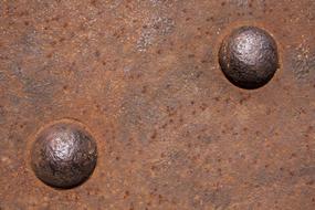 a pair of riveters on a rusty metal fence