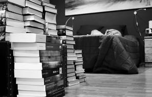 many books near the bed in the room