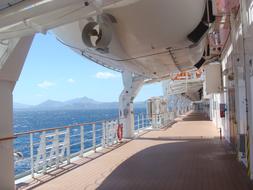 view from the deck of a large ship to the brilliant sea