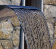 Water fountain at stone wall close up