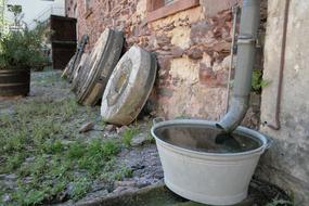 downpipe at wall over bowl with water