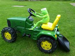 toy kermit on a green tractor