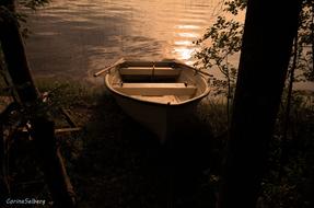 wooden boat by the lake in the evening