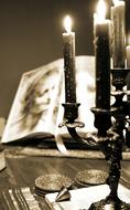 candlestick near the book in monochrome