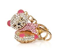Close-up of the beautiful and colorful, shiny Teddy Bear key ring, with reflection, at white background