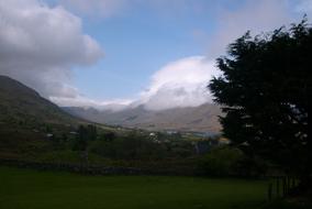 Beautiful landscape with the meadow, among the mountains and plants, in Ireland