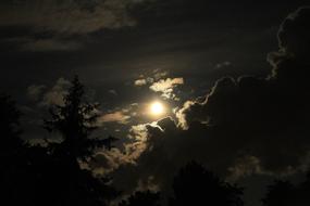 Beautiful, bright Moon in the sky with clouds, at the night