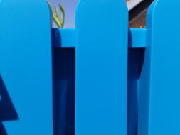 bright blue plastic fence close up