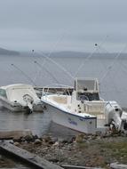 Boats on the coast of Moosehead Lake in USA, under the clouds