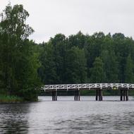 white wooden bridge over a lake in Finland