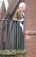 actress in traditional costume on the balcony of a fortress in england