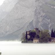 castel toblino in thick fog in Italy
