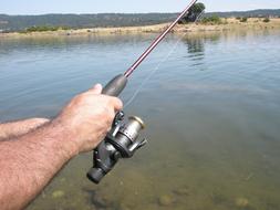 fishing rod in the hands of a fisherman