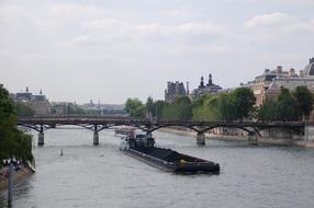 boat with seine on the river near the bridge in paris