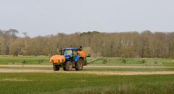 Tractor Spraying Crop landscape