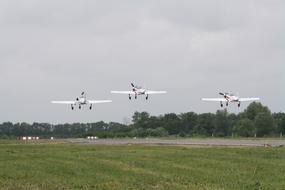 three planes over the runway