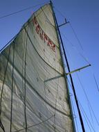 Close -of the sail of the yacht, under the blue sky