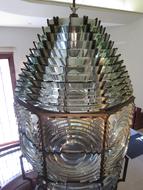 Shiny glass lighthouse with shapes, in light