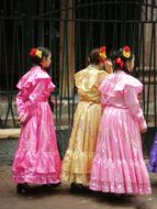 asian women in dresses on city street