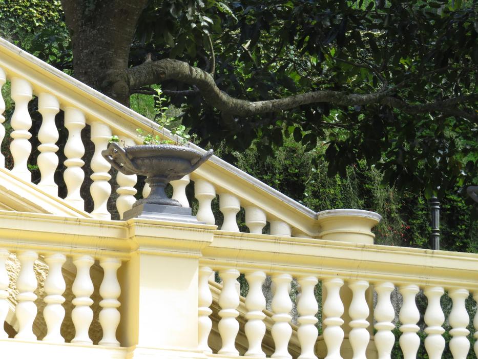 Beautiful, yellow and white railings of the Camera Palace, with plants