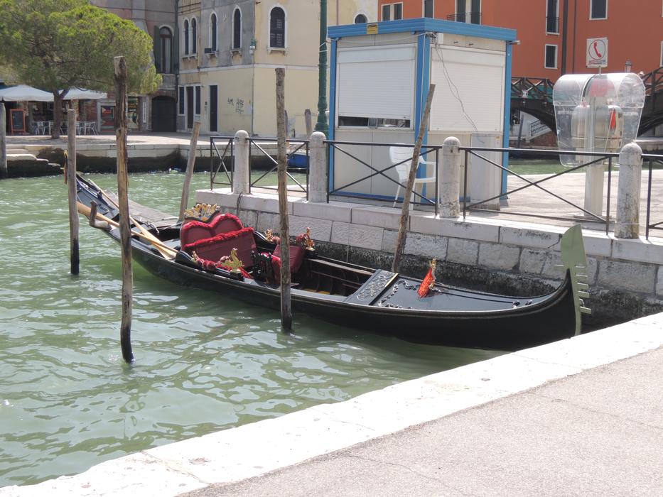 the gondola is parked near the shore