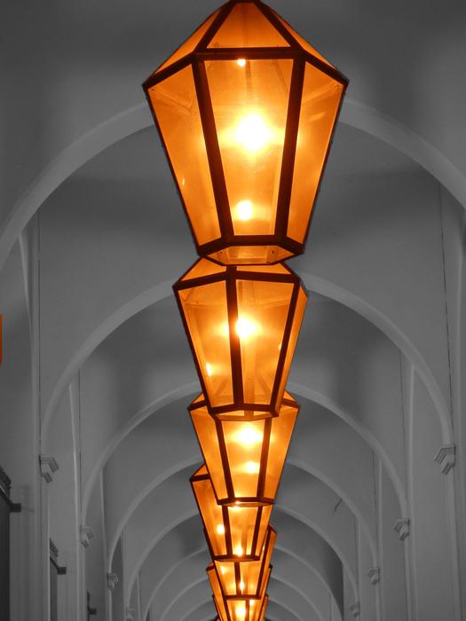 burning lanterns on the arched ceiling in the building