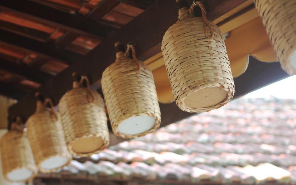 Bottles Of Wine in Demijohns hanging beneath ceiling