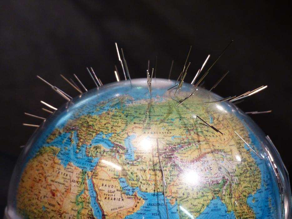 needles on top of the globe