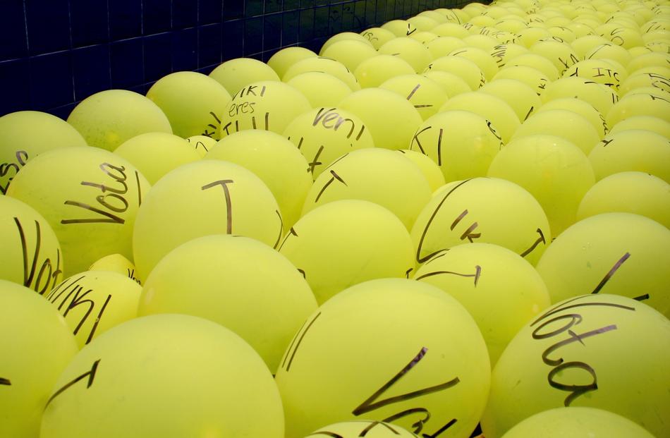 many yellow balloons with inscriptions