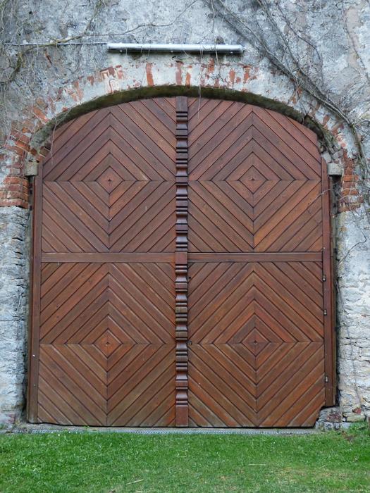 the brown wooden gate of the fortress