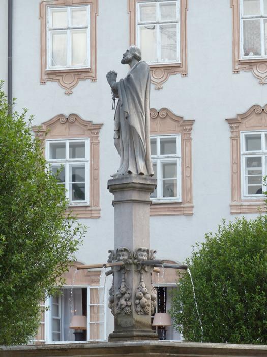 sculpture of saint rupert in the fountain in the courtyard of the abbey